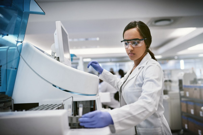 A biochemist testing a substance using chemistry equipment  