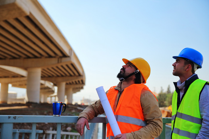 A civil engineering technician discusses a project with a contractor