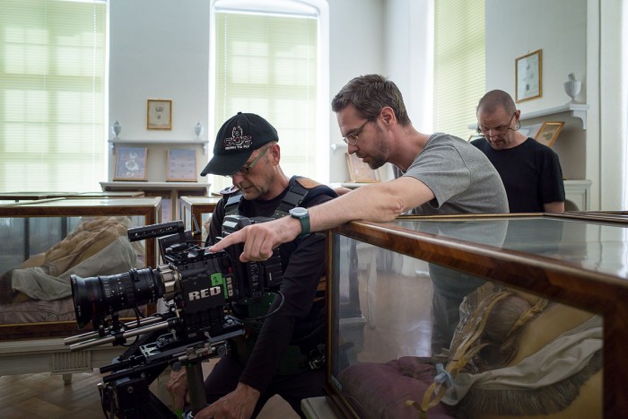 A director shows a steadicam operator how they want a scene to be shot