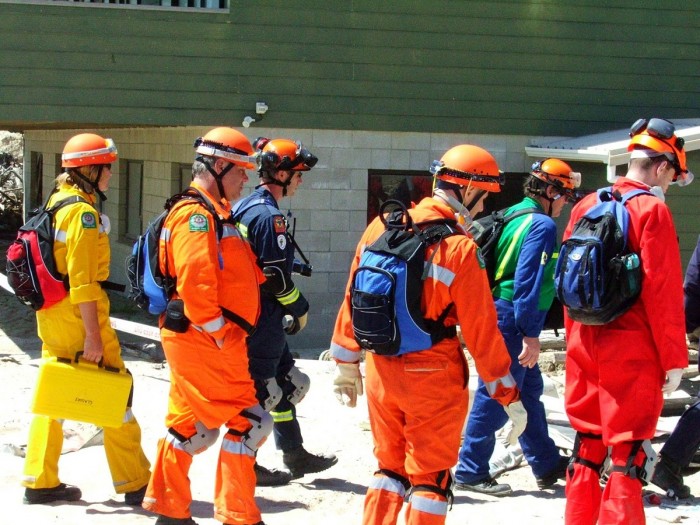 Emergency management officers dressed in uniforms doing an outdoor exercise