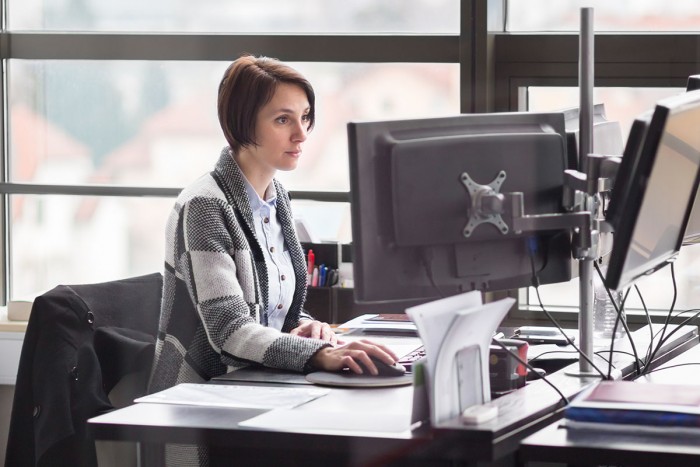 Woman working at a workstation computer