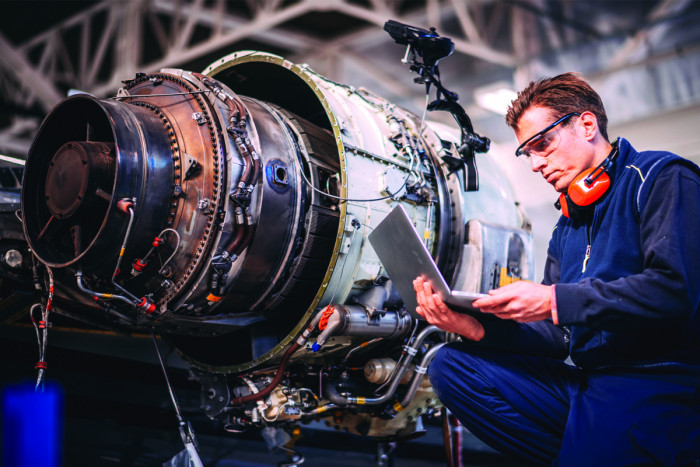 Mechanical engineering technician repairing an engine 