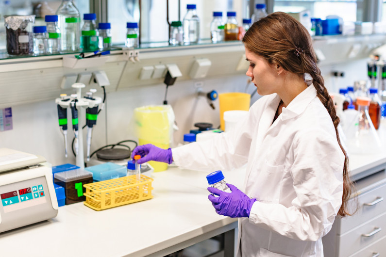 A laboratory technician examines test samples in a laboratory