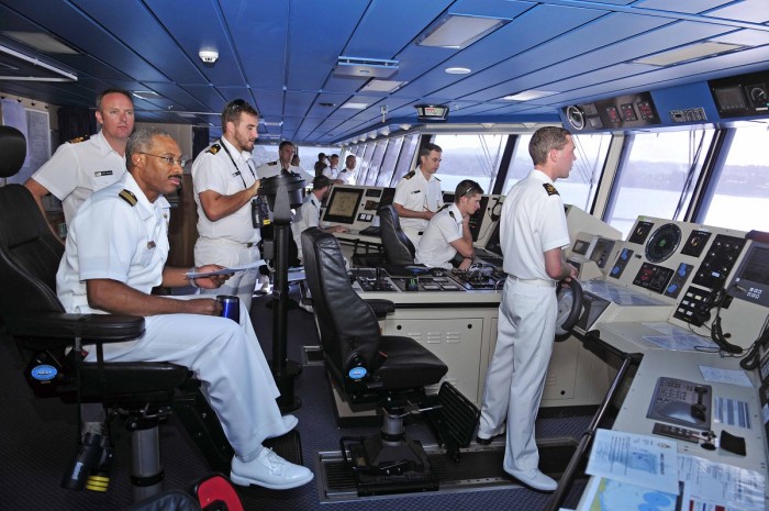 US Navy officers, NZ Navy officers and NZ Navy sailors taking part in a joint exercise on board a frigate