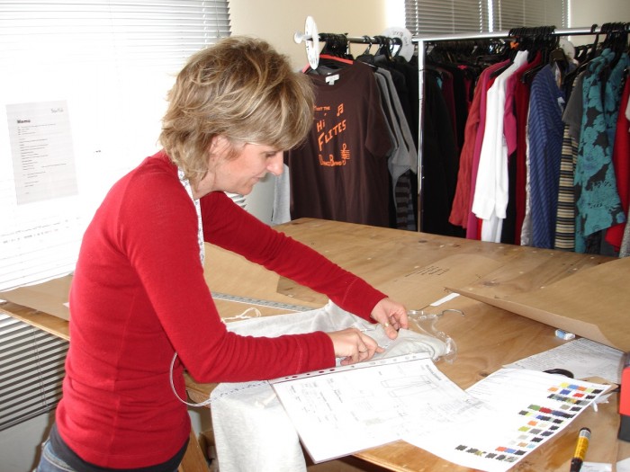 Sonya Whitticase working on a clothes pattern at a desk