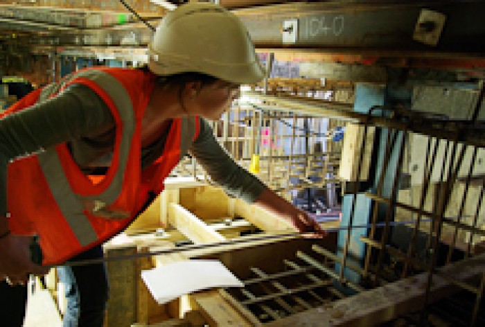 Quantity Surveyor - quantity surveyor karen o rourke using a tape measure at a building site