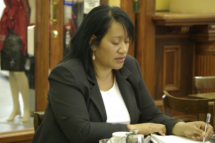 Lina Siu writing notes in a cafe