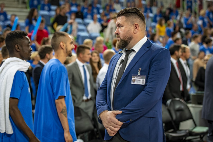 A security guard watches the crowd during a basketball game