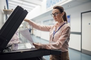 Women photocopies a document