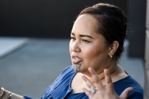 A wahine with ta moko speaks to an audience