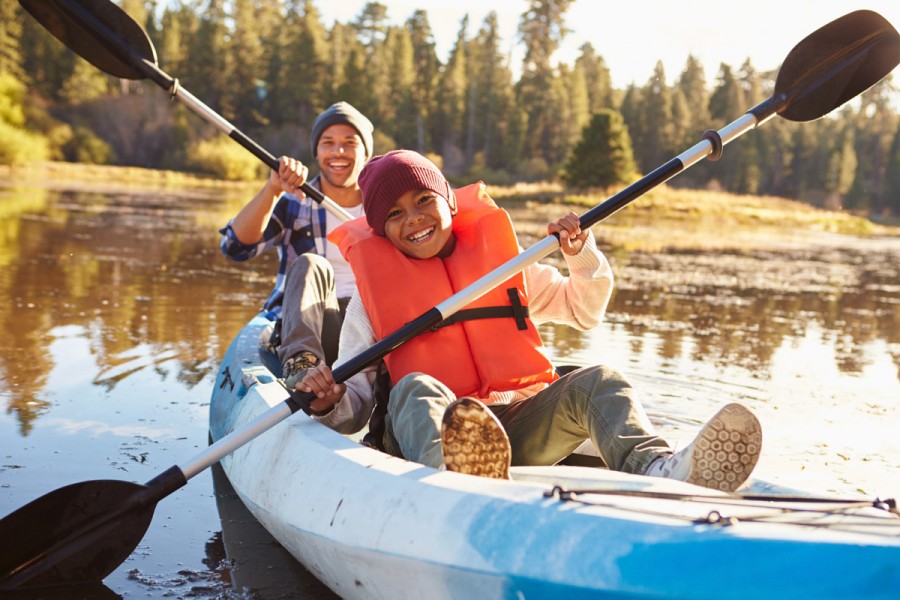 A student kayaks with a camp instructor